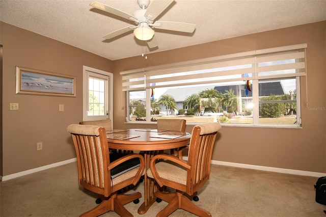 dining area with carpet floors, a textured ceiling, and ceiling fan