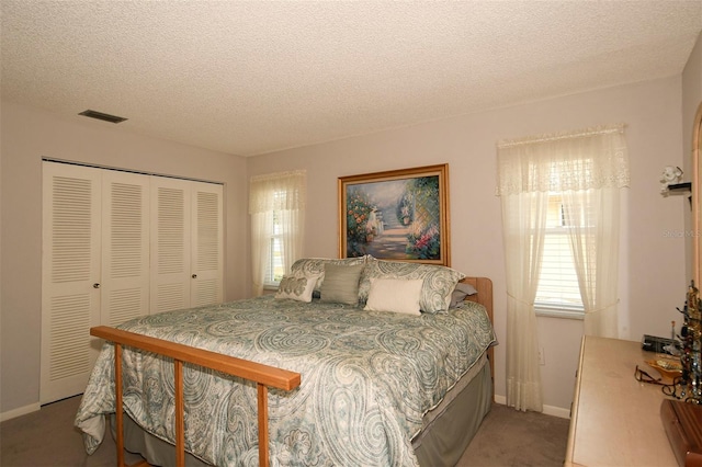 bedroom featuring carpet, a textured ceiling, and a closet