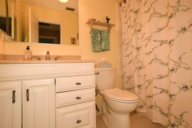 bathroom featuring vanity, toilet, and tile patterned floors