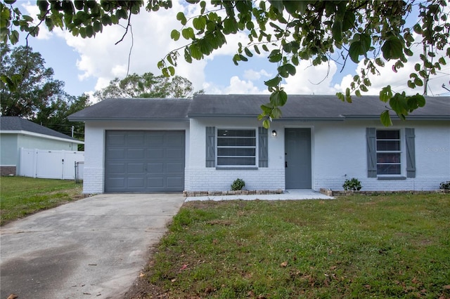 single story home featuring a front lawn and a garage