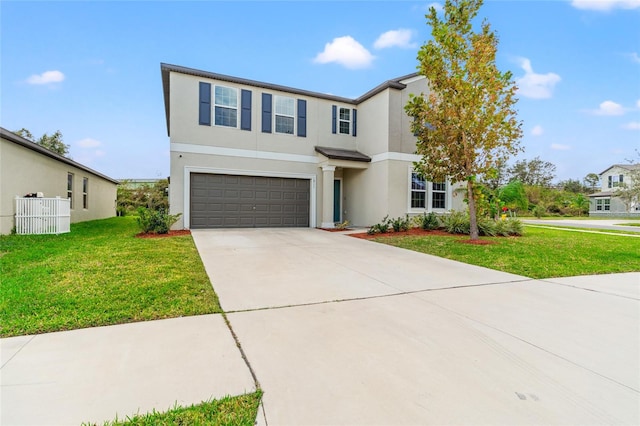 view of property with a front yard and a garage