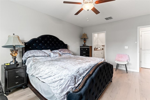 bedroom featuring ceiling fan, light wood-type flooring, and ensuite bath