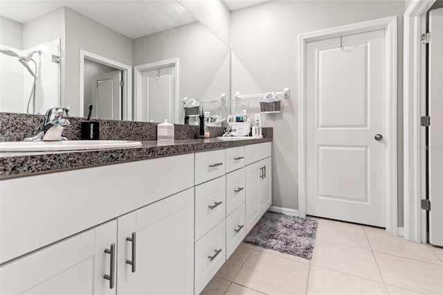 bathroom featuring vanity, walk in shower, and tile patterned floors