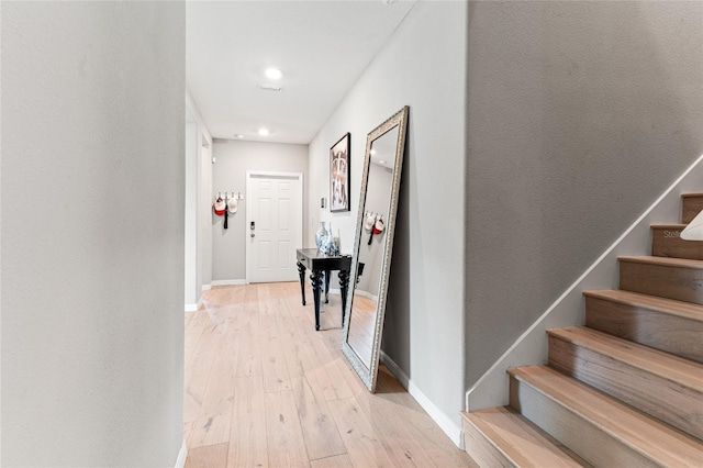 hallway with light hardwood / wood-style flooring