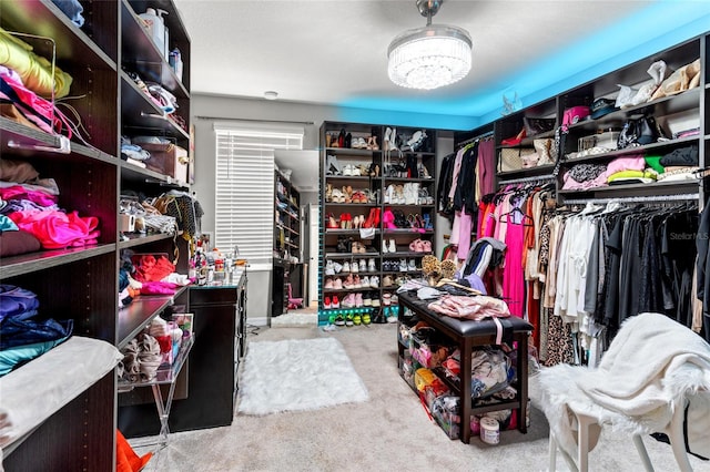 walk in closet featuring light colored carpet