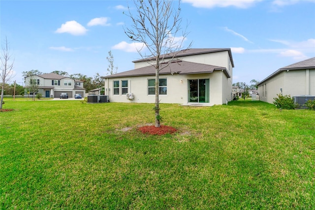 back of house with a lawn and central AC unit