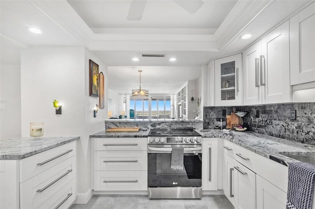 kitchen featuring kitchen peninsula, hanging light fixtures, white cabinetry, light stone countertops, and electric stove