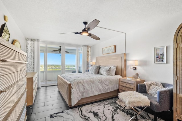 tiled bedroom featuring a textured ceiling and ceiling fan