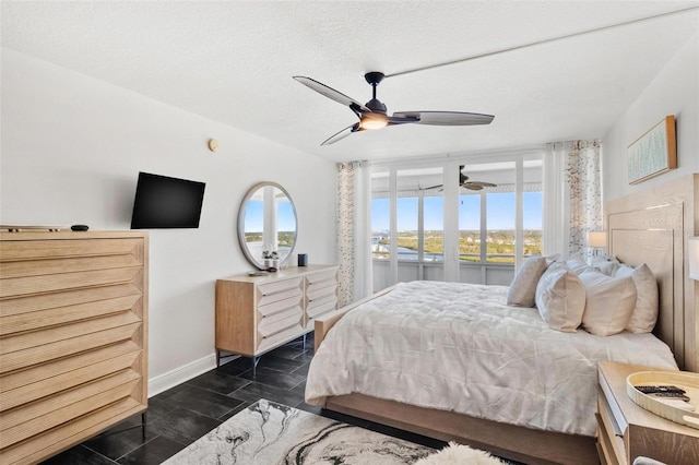 bedroom featuring a textured ceiling and ceiling fan