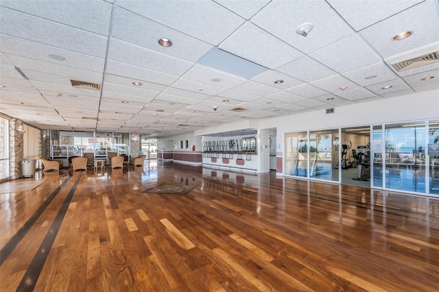 interior space with hardwood / wood-style flooring and a paneled ceiling