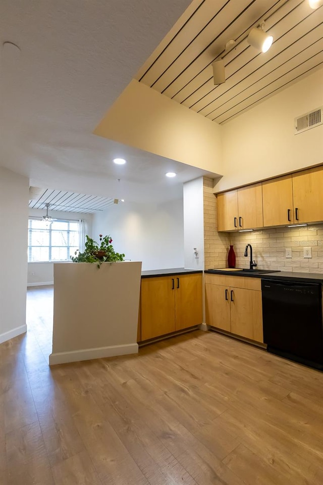 kitchen with backsplash, track lighting, sink, light hardwood / wood-style flooring, and dishwasher