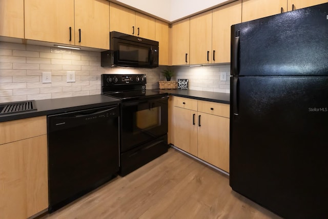 kitchen featuring decorative backsplash, light brown cabinetry, black appliances, and light wood-type flooring