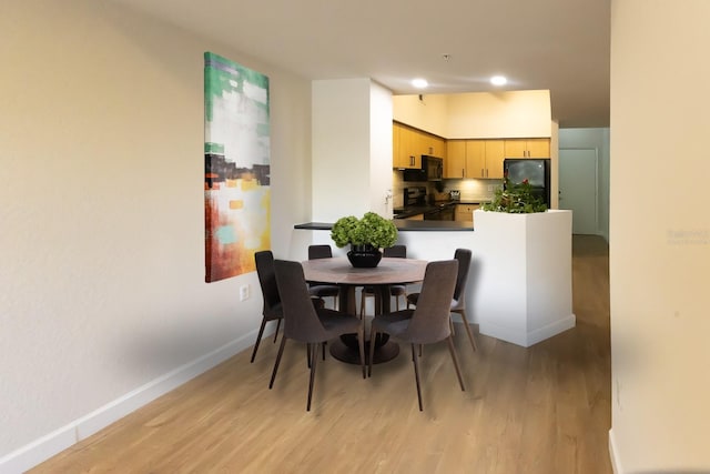 dining space featuring light wood-type flooring