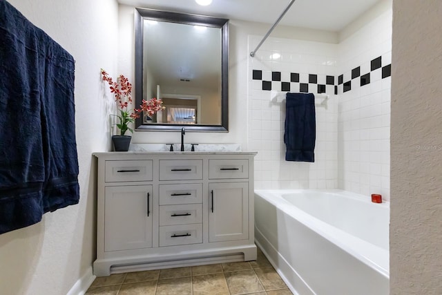 bathroom with tile patterned floors, vanity, and tiled shower / bath combo