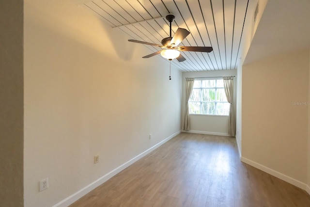 empty room featuring vaulted ceiling, light hardwood / wood-style flooring, ceiling fan, and wooden ceiling