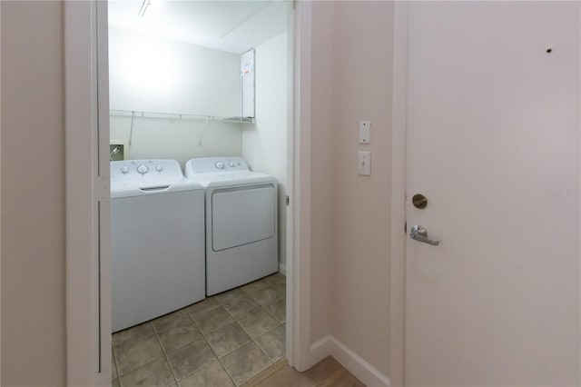 washroom with washer and clothes dryer and light tile patterned flooring