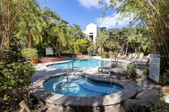 view of pool featuring a patio area and a community hot tub