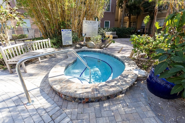 view of swimming pool with a patio and a hot tub