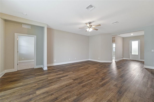 empty room with ceiling fan and dark hardwood / wood-style flooring