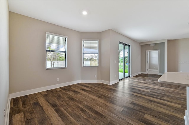 unfurnished room with dark hardwood / wood-style floors