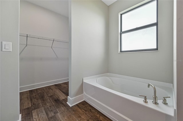 bathroom featuring a bath and hardwood / wood-style flooring