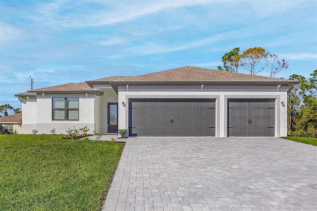 view of front of home with a garage and a front yard