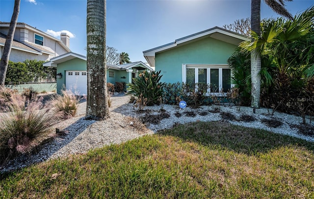 exterior space featuring a garage and a yard