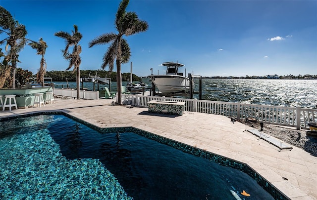 view of pool with a water view, a dock, and a patio area