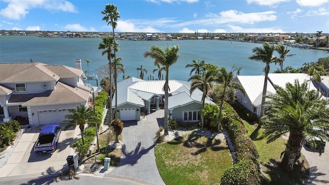 drone / aerial view featuring a residential view and a water view