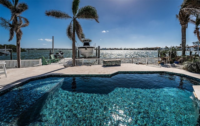 pool with a patio and fence