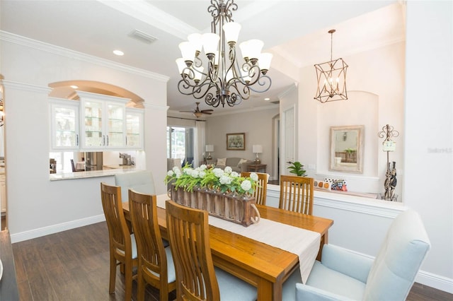 dining room with ornate columns, dark hardwood / wood-style flooring, ceiling fan, and crown molding