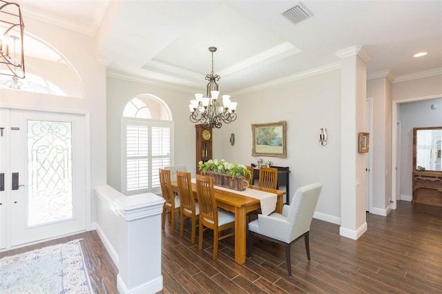 dining space featuring ornamental molding, dark hardwood / wood-style flooring, a notable chandelier, and a raised ceiling