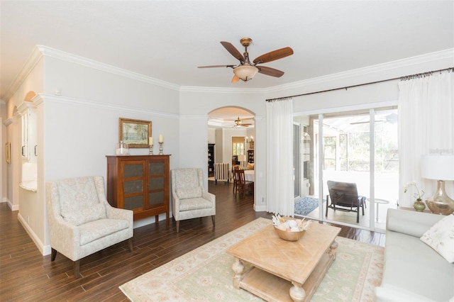 living room featuring dark hardwood / wood-style flooring, ceiling fan, and crown molding