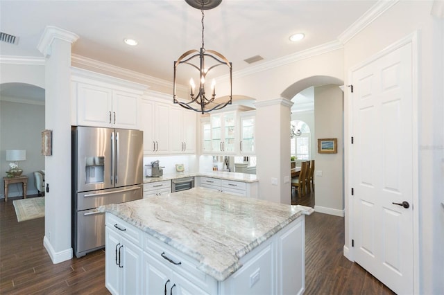 kitchen with dark hardwood / wood-style flooring, white cabinets, stainless steel refrigerator with ice dispenser, a kitchen island, and light stone countertops