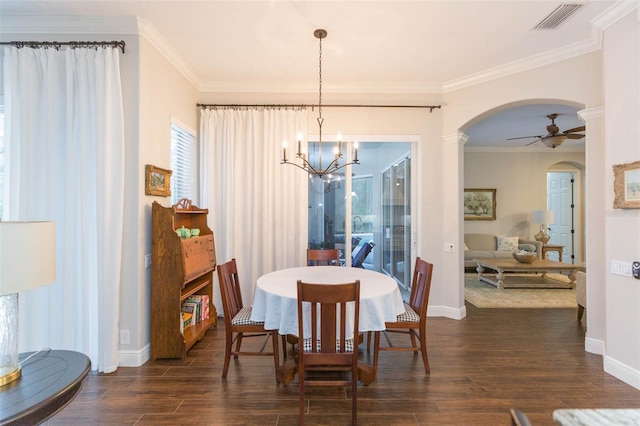 dining room featuring dark hardwood / wood-style floors, crown molding, and ceiling fan with notable chandelier