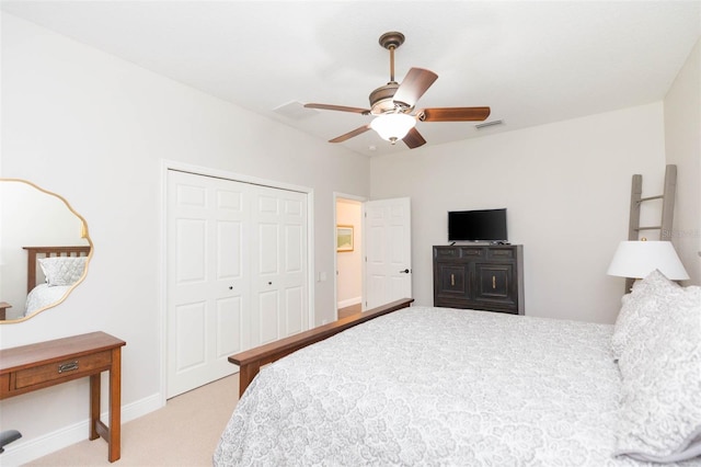 carpeted bedroom with ceiling fan and a closet