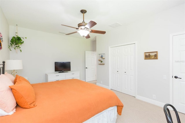 carpeted bedroom featuring a closet and ceiling fan