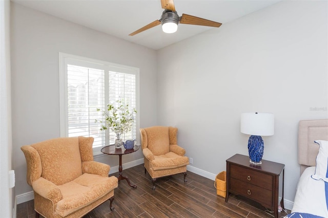 sitting room with ceiling fan and dark hardwood / wood-style floors