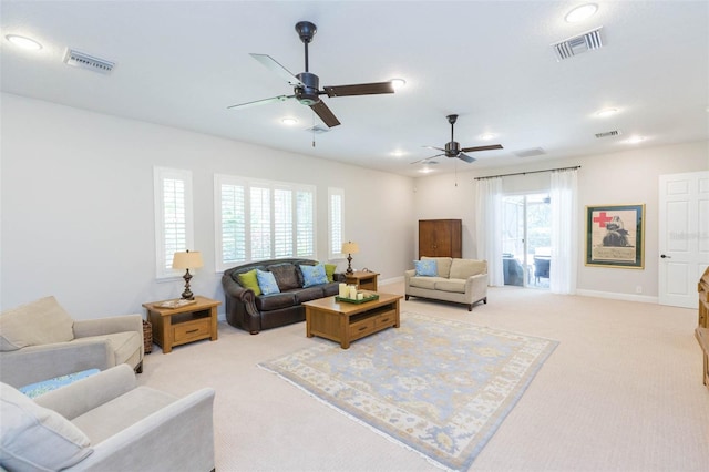 carpeted living room with plenty of natural light and ceiling fan