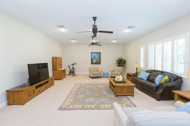 living room featuring light colored carpet and ceiling fan