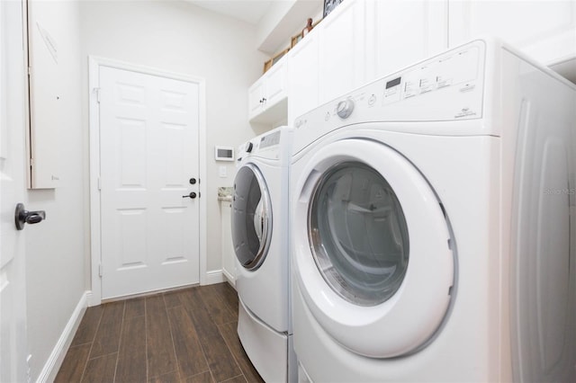 laundry area with washing machine and clothes dryer and dark hardwood / wood-style floors