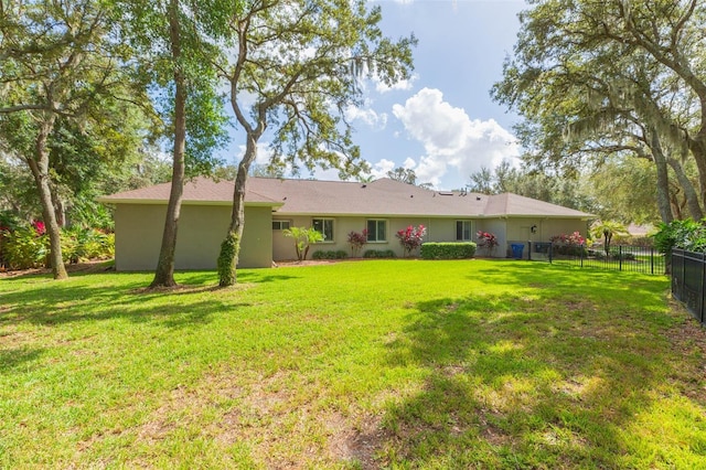 back of house featuring a lawn