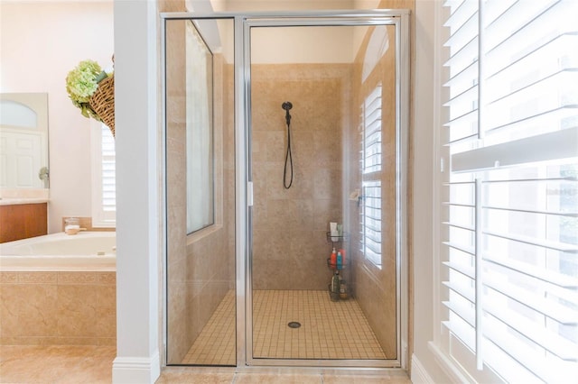 bathroom with tile patterned floors and separate shower and tub