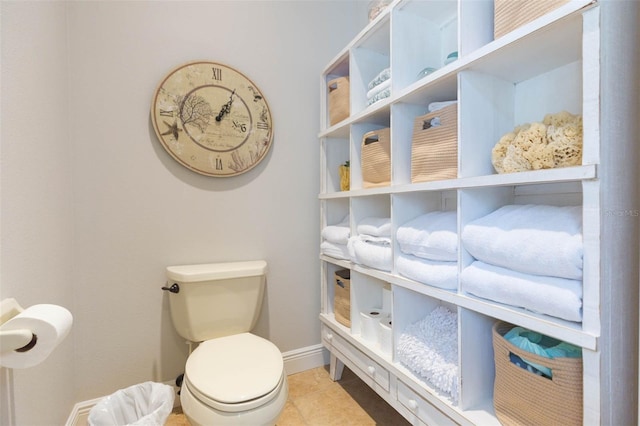 bathroom featuring toilet and tile patterned flooring