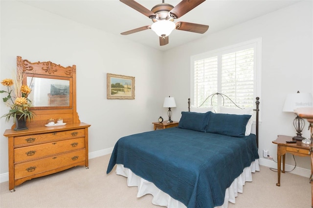 bedroom featuring ceiling fan and light carpet