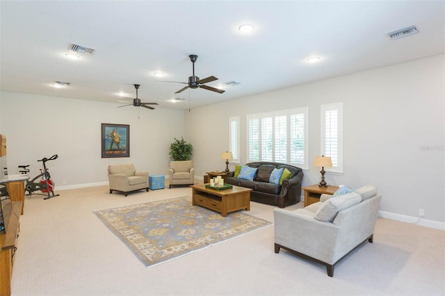 living room featuring light colored carpet and ceiling fan