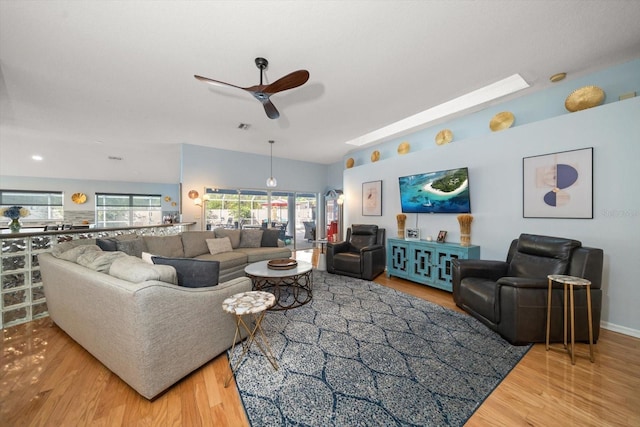 living room with ceiling fan and hardwood / wood-style floors