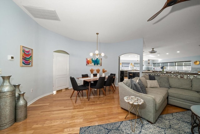 living room featuring ceiling fan and light hardwood / wood-style floors