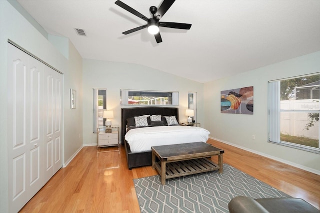 bedroom with vaulted ceiling, ceiling fan, a closet, and wood-type flooring