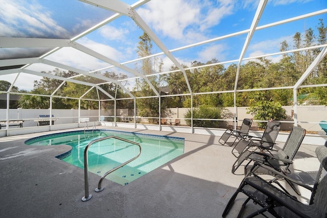 view of swimming pool featuring a lanai and a patio